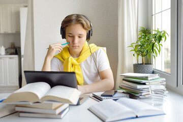 Teenager boy study at home. Online education and distance learning for children. School boy doing...