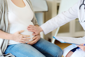 Gynecologist doctor accepts of a pregnant woman. Medical insurance childbearing. Family doctor for...