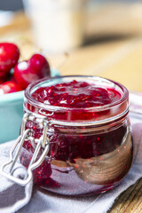 An airtight glass jar filled with berry jam