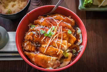 Japanese chicken teriyaki with rice and vegetables. Plate of teriyaki chicken with rice on the table, top view