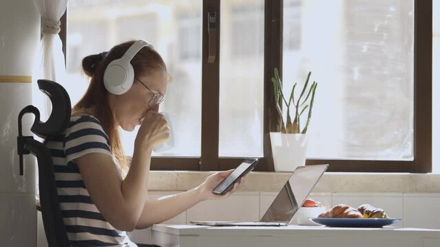 Business woman work at home with a phone and lapto