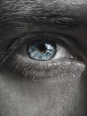 Black and white photo of the blue colored of the iris of the eye. Man eye images.