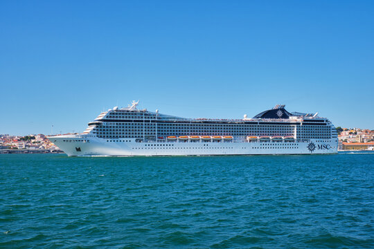 Lisbon, Portugal - August 31, 2022: MSC Orchestra cruise ship of Musica class leaving Lisbon in Tagus river. She could at the time accommodate 2,550 passengers in 1,275 cabins