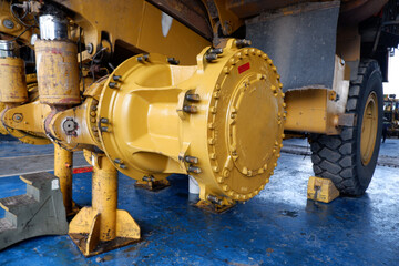 final drive and wheel hub of a giant mining dump truck being serviced at workshop