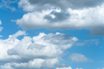 Naklejka na ściany i meble Clouds on a sunny day on a blue sky