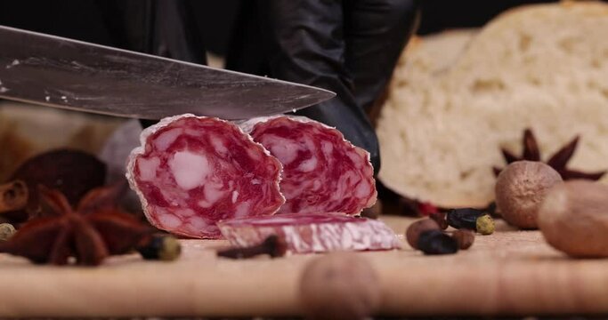 Slicing pork sausage with white mold , dried meat with spices and in white mold close - up
