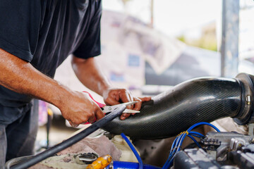 Auto mechanic repair engine in a car repair shop and Checking a car engine for repair at car...
