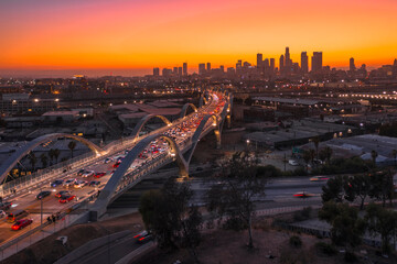 Sunset or sun rise over a bridge with Los Angeles City Skyline The Ribbon Of Light- 6th Street Bridge