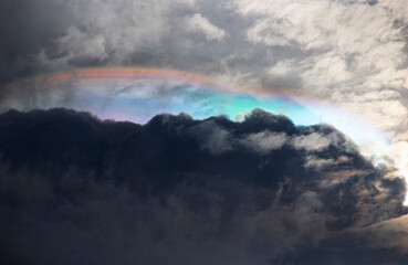 Fototapeta na wymiar Fire Rainbow in the sky with clouds and rainclouds as background