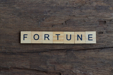 fortune text on wooden square, business quotes