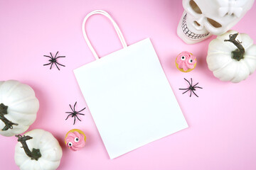 Halloween treat bag mockup. Pink background new season colors. Trick or treat party supplies...
