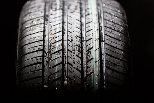 Brand new tire on a black background closeup