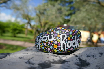 You rock encouraging message painted in script on kindness rock