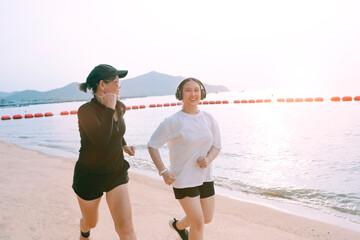 two asian woman running on sea beach with happiness