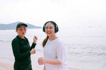 two asian woman wearing sport casual wearing happiness on sea beach