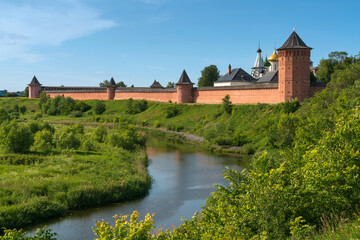 View of the Spaso-Evfimiev Monastery (a monastery of the Vladimir Diocese of the Russian Orthodox Church) on the bank of the Kamenka River on a sunny summer day, Suzdal, Vladimir region, Russia - obrazy, fototapety, plakaty