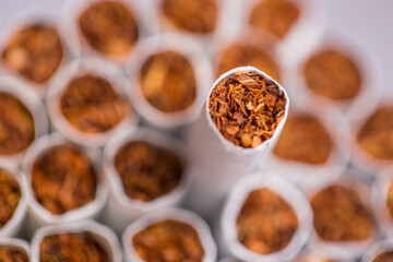 Burning cigarette with smoke and concept of cigarettes