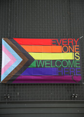 Vibrant gay pride rainbow flag intertwines with Juneteenth symbolism, celebrating freedom,...