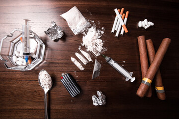 Concept of cocaine and other drugs on a table for an addict