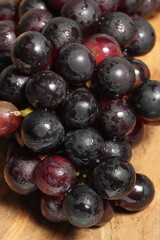 Black grapes on texture background