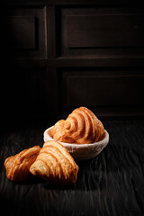 Freshly baked french croissant with dark mood theme
