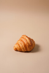 Freshly baked french croissant with beige background