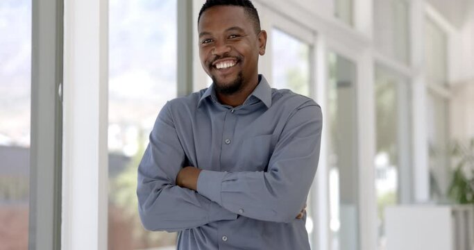 Happy black man, arms crossed and confidence for creative business or career ambition at the office. Portrait of confident African businessman smile with vision for startup by window at the workplace