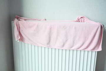 towel drying on heating radiator,