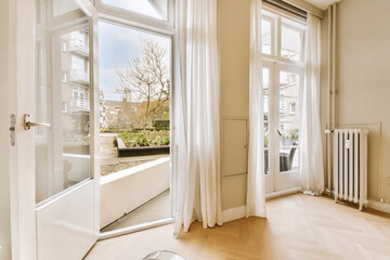 an empty living room with wood flooring and white drapes hanging on the window simnwh
