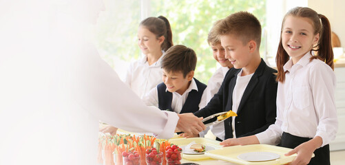 Group of pupils receiving lunch in school canteen. Banner for design