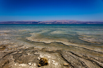 Shore of the Dead Sea. Mineral deposits visible under water. 