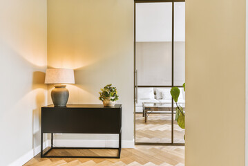 a living room with wood flooring and an open door leading to the outside patio, which has been used for several years