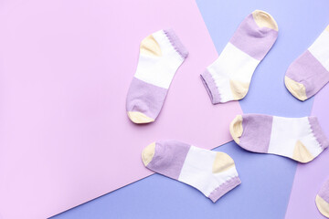 Many cotton socks on color background