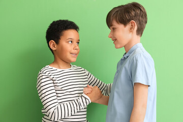 Cute little boys hugging on green background © Pixel-Shot