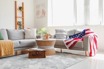 Interior of stylish living room with USA flag on sofa