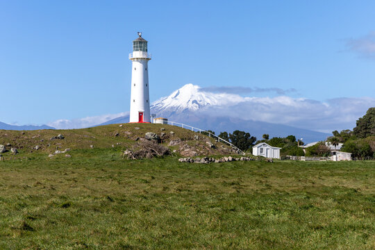 Cape Egmont lighthouse with Taranaki volcano at background, New Zealand