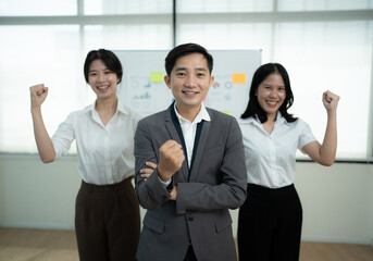 Group of positive asian business partners wearing suit standing crossed arms looking at camera with smiles. Asian corporate people.