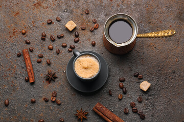 Cup and jezve of hot espresso on dark background