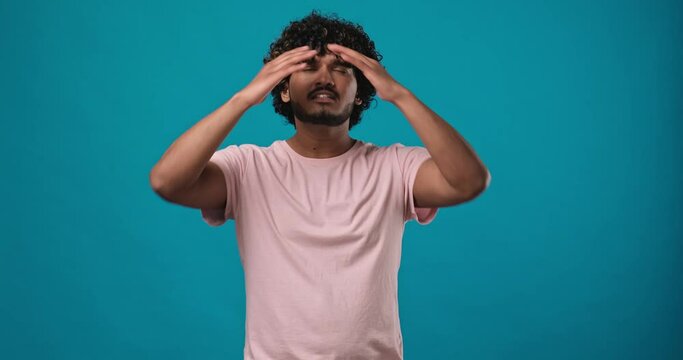 Frustrated indian man raising his hands and shrugging his shoulders with an indignant expression, asking the reason for the failure, showing disappointment, chagrin due to problems