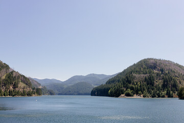 Beautiful view of the mountains and the big river. Beautiful summer landscape with mountains, trees and a lake. Nature in Oregon in spring. Panorama with big blue mountains and river