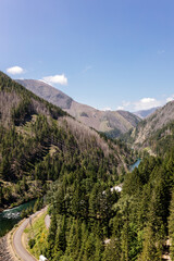 Beautiful view of the mountains and a large river from a bird's eye view. Beautiful summer landscape with mountains, trees and a river. Nature in Oregon in spring. Detroit Dam