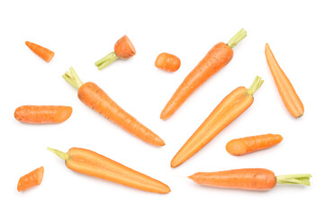 Fresh carrots and slices on orange background