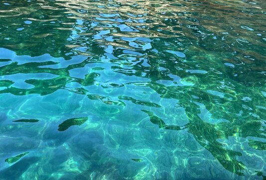 Glittering sea water blue turquoise watercolor surface.