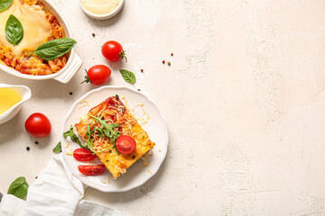 Baking dish and plate of pasta with tomato sauce on white background