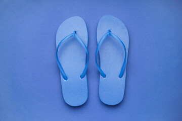 Blue flip-flops on color background
