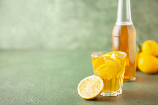 Boozy Refresing Cold Lemon Deer or Radler in a Pint Glass  on wooden table. Copy space
