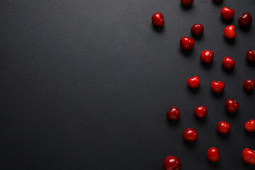 Many sweet cherries on black background