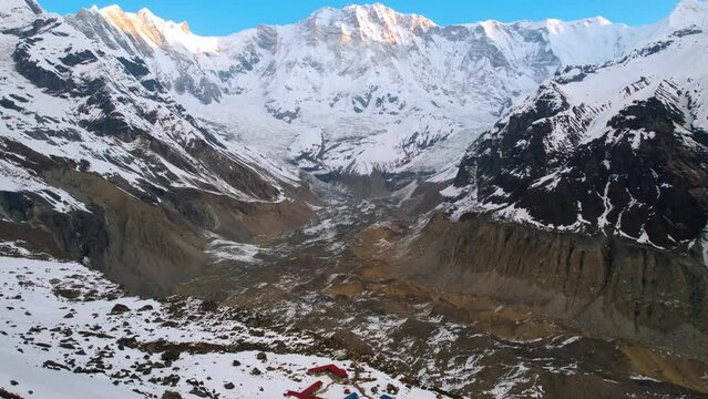 Sunlight shines on snowy gletcher mountain peaks at annapurna base camp nepal