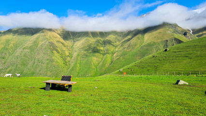 landscape in the mountains with wood table and chair
