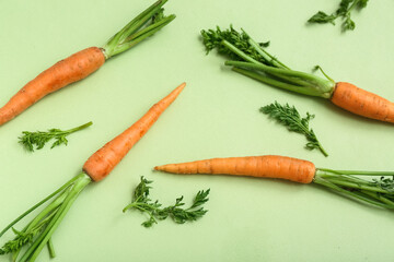 Fresh carrots on light green background